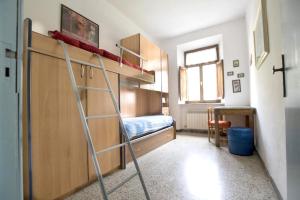a room with a bunk bed and a ladder at 2 bedrooms apartement with shared pool and wifi at Massa Marittima in Massa Marittima