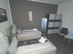 a living room with two beds and a tv at Apartament Suite 2 in Bernburg