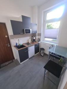 a small kitchen with a sink and a window at Apartament Suite 2 in Bernburg