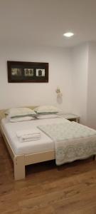 a white bed in a room with aoked at Theo House in Sibiu