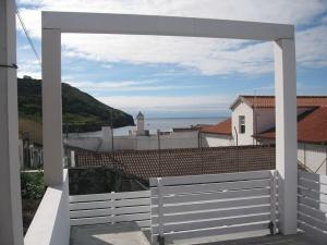 a view from the balcony of a house with a white fence at Baía das Caldeirinhas in Horta