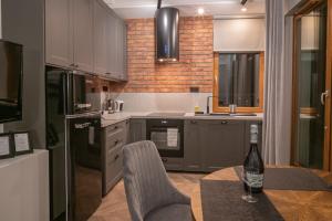 a kitchen with a table and a bottle of wine at Labo Apartment Metro Młociny in Warsaw