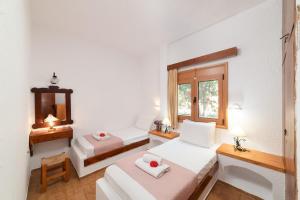 Postel nebo postele na pokoji v ubytování Kounenos Apartments