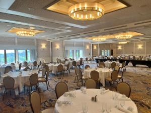 a banquet room with tables and chairs and a grand piano at Oglebay Resort in Wheeling