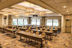 a large room with tables and chairs and chandeliers at Oglebay Resort in Wheeling