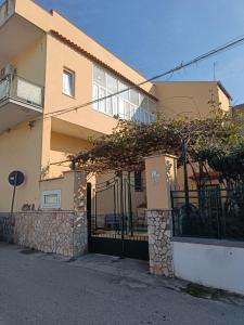 a building with a gate in front of it at Villa Carmela Capotosto in Mondragone