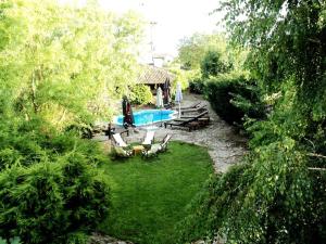 a backyard with a swimming pool and chairs and a house at VILLA GALATA in Varna City +25 photos