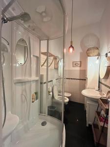 a bathroom with a shower and a toilet and a sink at H33 Boutique Apartment in Livorno centro in Livorno