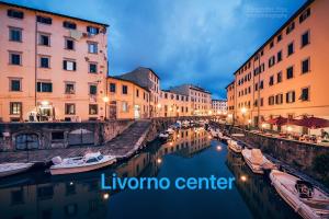 a view of a canal in a city at night at H33 Boutique Apartment in Livorno centro in Livorno