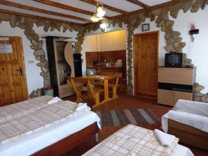 a room with two beds and a table and a kitchen at VILLA GALATA in Varna City