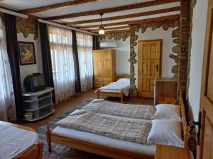 a bedroom with two beds and a tv in it at VILLA GALATA in Varna City