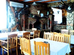 a dining room with tables and chairs and a fireplace at VILLA GALATA in Varna City