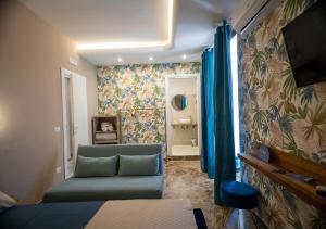 a living room with a couch and a tv in a room at Le stanze di Cloe in Naples