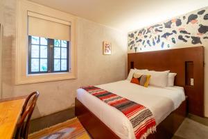 a hotel room with a bed and a window at Catahoula Hotel New Orleans in New Orleans