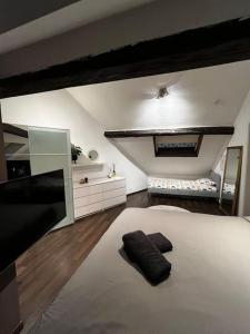 a bedroom with a large white bed in a room at Loft pour escapade en amoureux ou en famille. in Chaudfontaine