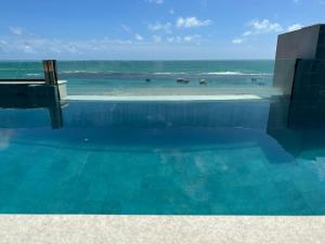 Bazén v ubytování Porto Galinhas frente mar Mikonos nebo v jeho okolí + 7 fotografií