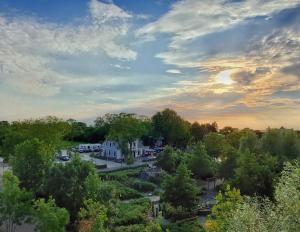 an aerial view of a house with a lot of trees at Villa Küstenwind in Butjadingen