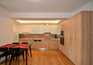 a kitchen with a table and a dining room at EFI Residence Holzova 28 in Brno
