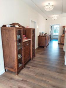 a room with a large wooden cabinet in a room at Villa Küstenwind in Butjadingen