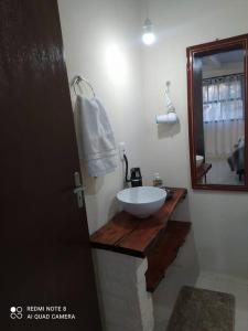 a bathroom with a sink and a mirror at Casa Hermosa in Igrejinha