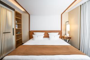 a bedroom with a large bed and a window at Five Seas by Inwood Hotels in Cannes