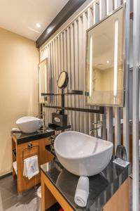 a bathroom with a large sink and a mirror at Five Seas by Inwood Hotels in Cannes