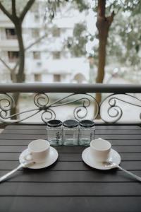 a couple of cups and saucers on a table at Stunning 3BR @Maricielo Villas in Manila