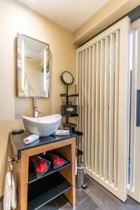 a bathroom with a sink and a mirror at Five Seas by Inwood Hotels in Cannes