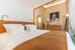 a bedroom with a large bed with white pillows at Five Seas by Inwood Hotels in Cannes