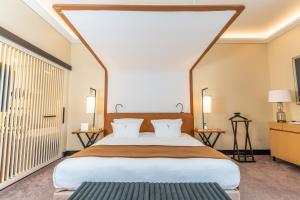 a bedroom with a large bed and a large window at Five Seas by Inwood Hotels in Cannes