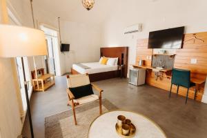 a hotel room with a bed and a table and chairs at Catahoula Hotel New Orleans in New Orleans