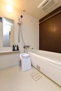 a bathroom with a toilet and a tub and a sink at ENT TERRACE AKIHABARA in Tokyo