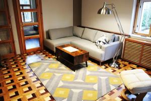 a living room with a couch and a coffee table at Louvre in Mariánské Lázně +53 photos