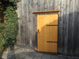 una puerta de madera en el lateral de una valla en Ferienhaus am Eichert, en Furth im Wald