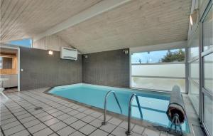 a swimming pool in a house with a large window at 4 Bedroom Stunning Home In Hirtshals in Hirtshals