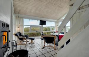 a room with a staircase and chairs and a living room at 4 Bedroom Stunning Home In Hirtshals in Hirtshals