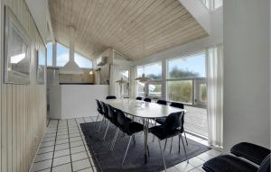 a kitchen and dining room with a table and chairs at Amazing Home In Hirtshals With Indoor Swimming Pool, Sauna And 4 Bedrooms in Hirtshals