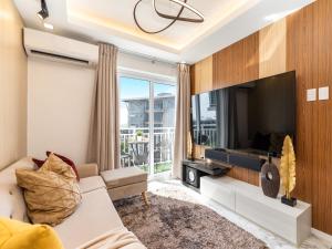 a living room with a couch and a tv at 537 AMANI LUXURY SUITE, 3 Minutes to Airport, FAST WIFI, Free Netflix in Pusok