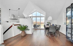 a kitchen and dining room with a table and chairs at 3 Bedroom Lovely Home In Skagen in Skagen