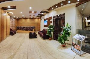 a large lobby with a couch and a tv at Regal Hotel in Ajmer