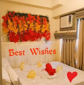 a bedroom with a bed with a sign that reads best wishes at Evelyn's Place at Tagaytay 2 in Tagaytay