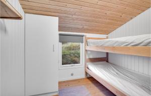 a tiny house with a window and two bunk beds at Nice Home In Hjrring With Kitchen in Lønstrup