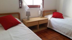 a bedroom with two beds and a desk with two lamps at Casa Silvia a due passi dal mare in Cavallino-Treporti
