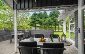 an outdoor dining area with a table and chairs at 4 Bedroom Amazing Home In Hjrring in Lønstrup