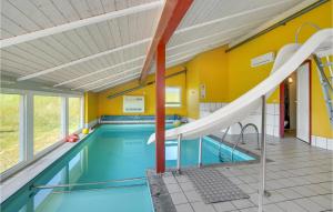an indoor swimming pool with a slide in a house at Nice Home In Bindslev With 4 Bedrooms, Sauna And Indoor Swimming Pool in Bindslev