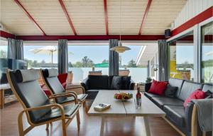 a living room with a couch and a table at Lovely Home In Bindslev With Sauna in Bindslev