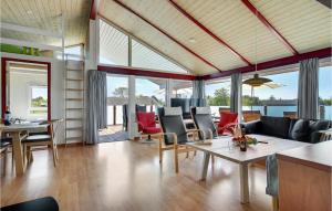 a living room with a couch and chairs and a table at Lovely Home In Bindslev With Sauna in Bindslev +18 photos