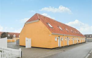 a large orange building with a red roof at Two-Bedroom Apartment In Lokken in Løkken