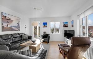 a living room with a couch and a tv at Gorgeous Apartment In Skagen With Kitchen in Skagen