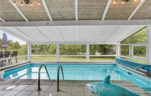 a swimming pool with a sharks head in a house at Beautiful Home In Bindslev With 4 Bedrooms, Wifi And Indoor Swimming Pool in Bindslev
